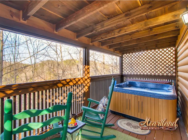 Hot tub and rocking chairs on the deck outside of the master bedroom